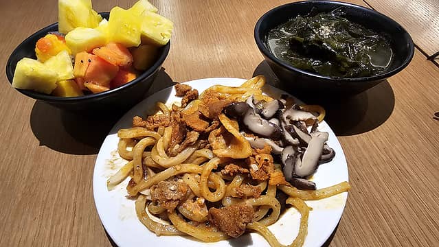 fruit, seaweed soup, udon noodles with mushrooms and meat