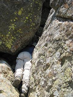 Dicey twisting into the entry (the tunnel isnt above her head, but underneath the boulder on the left)