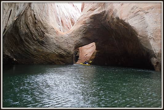 Chance paddleing under the arches of Anasazi Canyon