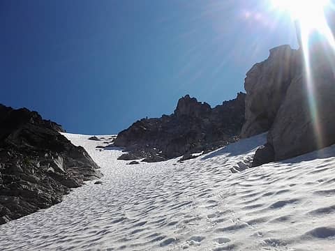 Looking up from midway of the snowy couloir