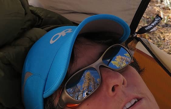 Larches thru the tent roof reflected in Carla's glasses