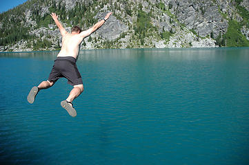 Me jumping off into the blue water of Lake Colchuck. Photo by John
