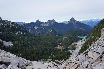 Necklace Valley from gap. Big Lake left is Locket Lake. Middle barely visible is Jade Lake, middle foreground is Opal Lake, right is first Cloudy Lake and then most showy is Lake Ilswoot. In distance is Mt. Baker and Monte Cristos with Columbia Glacier.