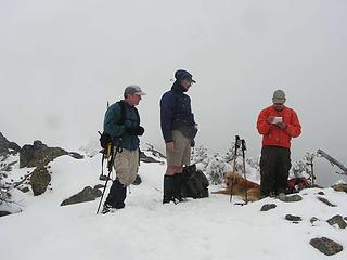 Snowing on the summit - David checking the summit register - How many days until summer?