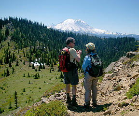 Hikers descend Noble Knob, Mt Rainier in the distance