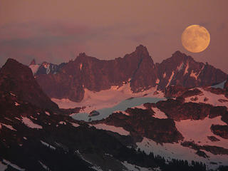 The moon rises in the evening alpenglow