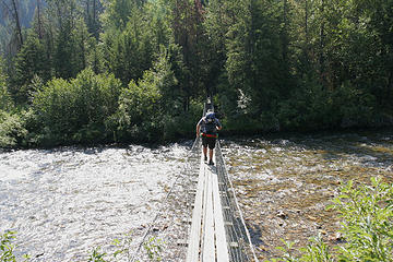 Connor crosses the West Fork Fish Creek on the hiker only suspension bridge, proposed Great Burn Wilderness Area, Montana.