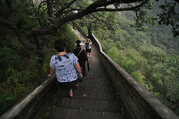 Stac heads down the stairs on an adjacent stair case to the Great Wall at MuTianYu.