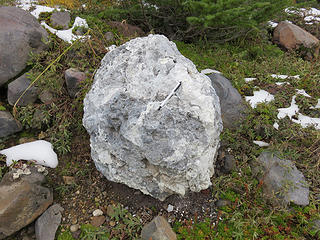 A distinctive volcanic material found in the Rocky Creek/Easton Glacier valley is informally known as 'shermanite' due to its origin in Sherman Crater. It is white to light gray hydrothermally altered rock that at one time was perfectly good andesite. Sulphurous gases and acidic water associated with fumaroles in Sherman Crater chemically deteriorated the andesite to make weak clay minerals (kaolinite, alunite, and smectite) as well as pure very white opaline silica. Bright yellow sulphur crystals can be found in some shermanite blocks.