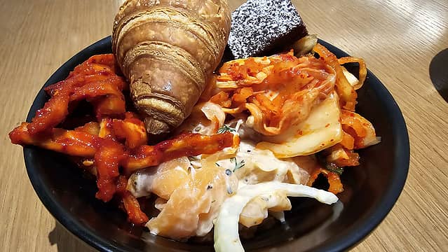 2 kimchi's with brownie and croissant, salmon sashimi with onion