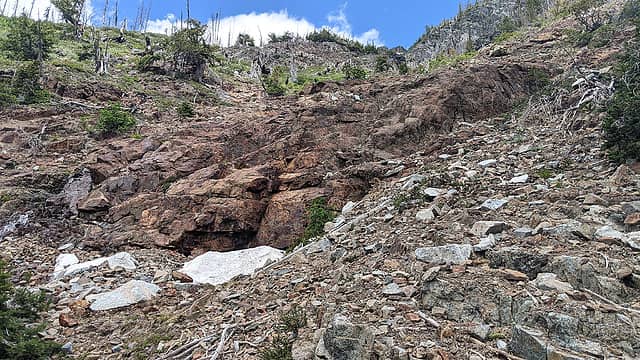 Mine site. Surface cuts visible; adit remains are behind the snow patch.