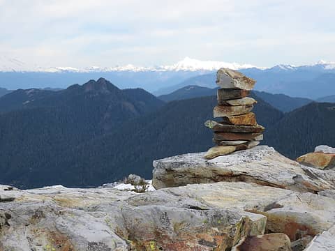 Cairn is obvious, but no register....mildly surprising considering the well-known prominence of Round Mountain. Baker teasing on the left,  Shuksan just left of cairn,  Finney Peak in middle distance. Rock of the summit block is rhyolite, either flows or ash-flow tuff ( Tbr).