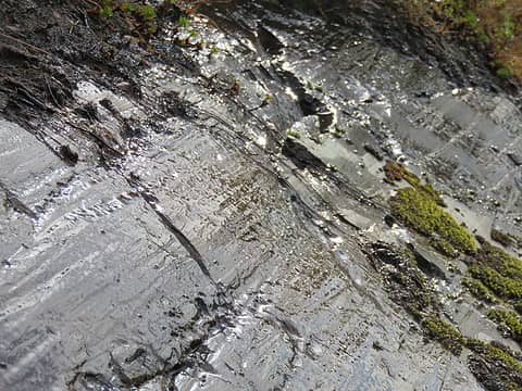 Striations and polish on bedrock. Striations are caused by pebbles being dragged across rock by moving ice. Individual striations are seldom more than a few meters long because the scratching pebble is worn away into the fine particles that cause polish, similar to abrasion with the grit glued to your sandpaper.