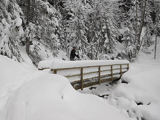 Snow-laden bridge across Mason Creek.  We learned the lower rails serve a good purpose when a chunk of the snow on the bridge collapsed underfoot and a snowshoed foot but not a body went off the edge.
