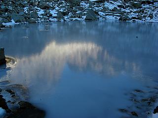 Ice reflection of cliff walls in Gully Tarn