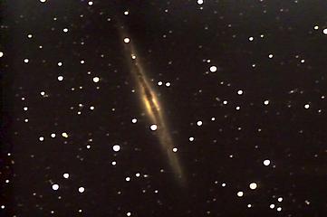 Spiral Galaxy NGC891, 32 million light years distant. Seen edge on. This shot is composed of 50 30 second subframes with a Meade Schmidt Newtonian 8" F4 telescope, Meade DSI-C imager, and Meade LXD75 mount.