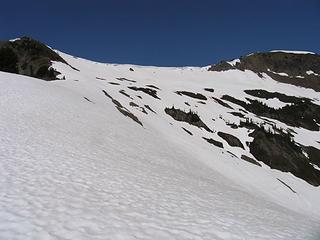 Looking up from the ridge above Rock Lake to the summit ridge (summit on right; route of ascent up to snow-free knoll on left).