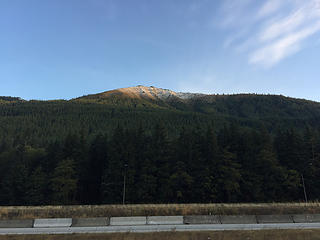 Granite Mountain top in the sun with snow from I-90.