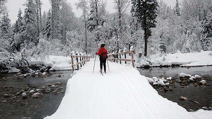 barb skiing over bridge