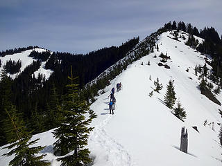 the route climbs this ridge and connects to the summit on the left via the forested ridge.