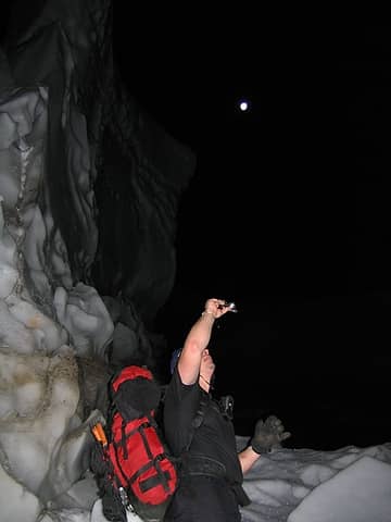 Tom, under the moon, taking  photos of giant snow blocks at the base of the Dry Creek Basin
