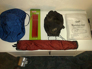 REI Elements rain hat, 
Coleman MSR copy stakes, 3 sets of 4, 
My old dirty OR gaiters, one snap missing on the top but they work fine, 
Design Salt mummy bag liner, never used, 
Big Agnes chair kit