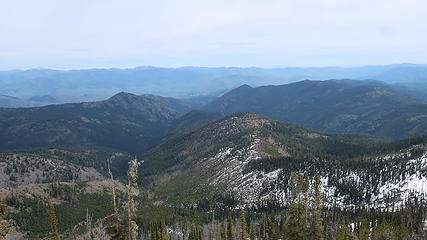view toward Twisp. Route follows most of the center ridge to near the round forested bump then down right to Wolf Creek trail