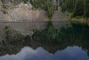 Smooth lake gives glassy reflection . . .