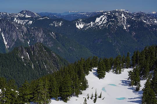 The snowy peaks in the far distance is Mt Pilchuck. Baker is hiding just behind Rooster and Goat and Index. The highest peak on the left is Twin Peaks. In the foreground is the tarn below Preacher Mountain.