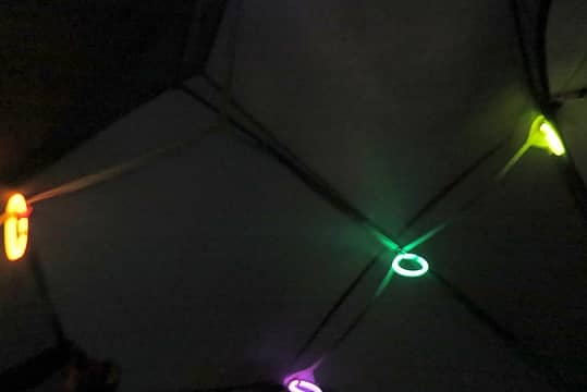 Glowing bracelets hanging inside the tent