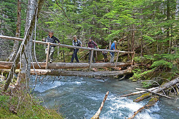 hikers crossing Heather Creek bridge