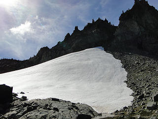 Snowfields encroaching on trail down from Knapsack Pass.