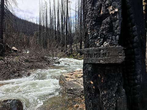 Burned Monument Creek sign.