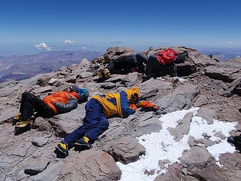 Tired Climbers On The Highest Rocks