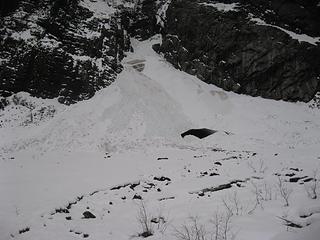 The Ice Caves snow cone pockmarked by avalanche debris.