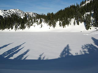 Three snowshoers on Hayes Lake - one on the far side (at upper right), two as shadows from the ridge (at lower right)