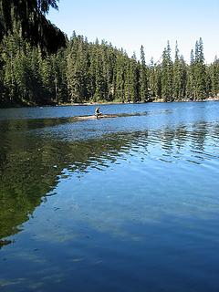 Fisherman on a log raft on Slide Lake
