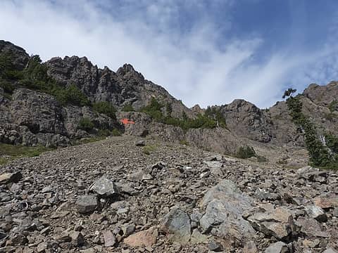 Upper scree slope heading to trail split, 50ft Class 4 rock section along Route B shown at arrow