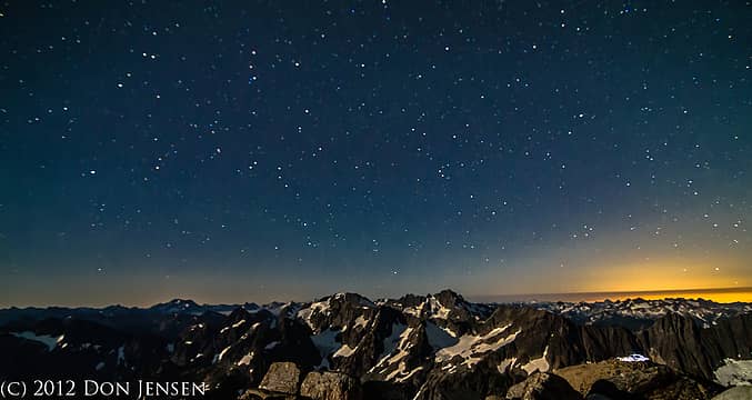 A sky full of stars over the North Cascades.  The yellow glow on the right is actually light polution from Everette/Seattle over 75 miles away in a straight line.