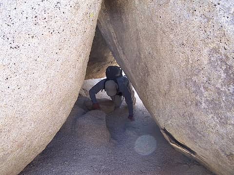 Crawling through another gap in the rocks