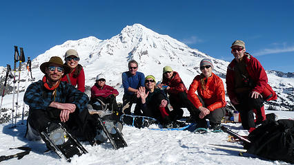 Happy friends basking in the warmth of a January sun on summit of Copper