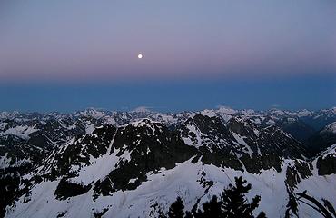 Pre-sunrise band dropping past the moon toward the horizon 4:47am