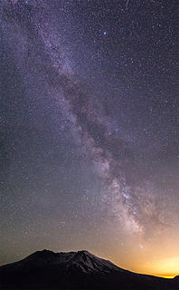 A three image pano of the milk way over Mount St. Helens as it descends into the light ball that is Portland.