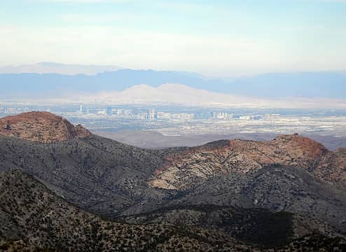 Virgin Mountain background left, Muddy Mountains in shadow, Frenchman Mountain in sunlight, and Vegas Strip foreground