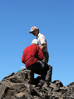 Steve holds the summit register, while  Mike takes pictures of the pages while on the summit of Volcanic Neck, 7.29.07.