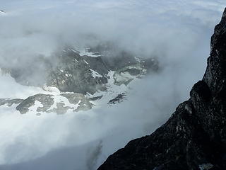 Peering through the cloud deck at a lake-tarn at the toe of the Honeycomb Glacier.