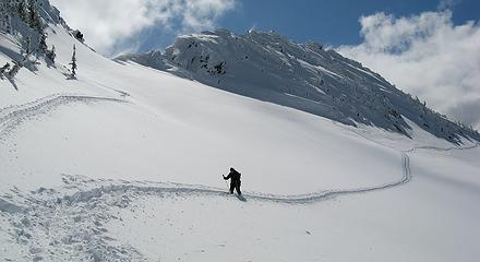 Eric returning across the snowfield below the col