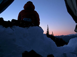 Andrew watches the sun set on Mt. Baker outside our shelter