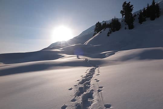 Hiking back up the snow dunes into the sun