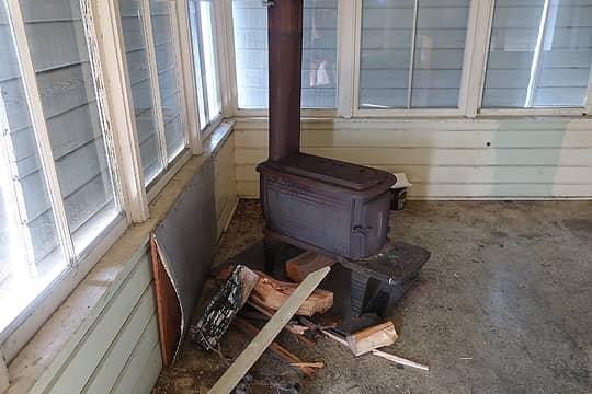and a wood stove, but otherwise the interior was bare.